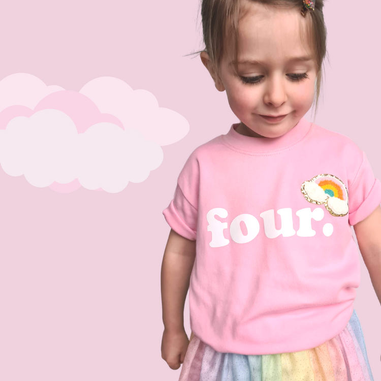 rainbow chenille patch on a 4th Birthday pink cotton t-shirt.