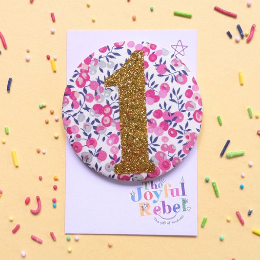 Birthday badge made of pink berries, gold sparkly '1', made by The Joyful Rebel.