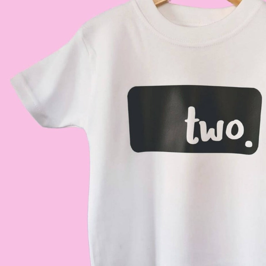 Hanging up white birthday with black 'two' logo from The Joyful Rebel