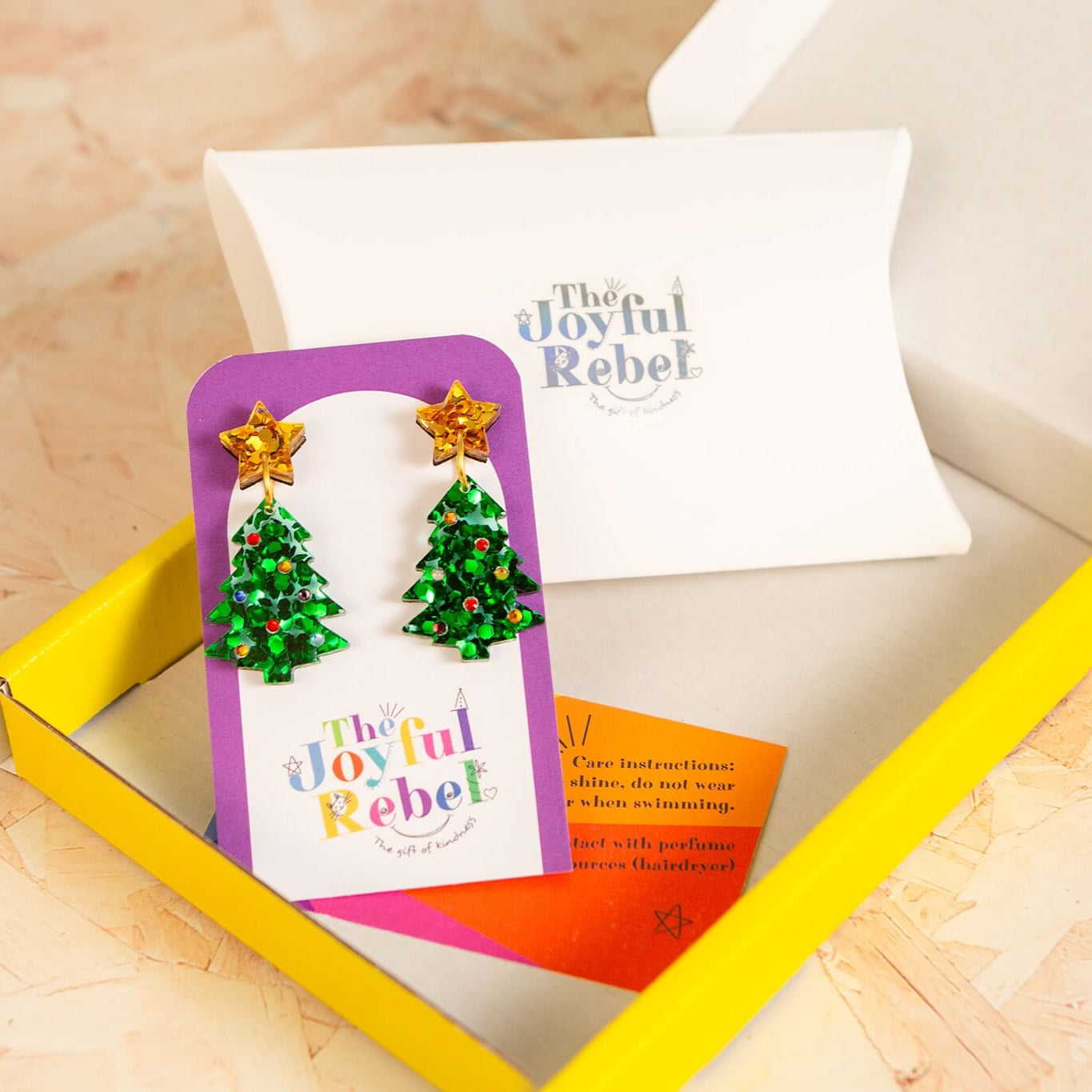 Plastic Free Product packaging with 'The Joyful Rebel' branding on a wooden surface