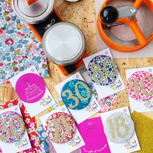 shows lot of different birthday badges - all different colours and numbers.