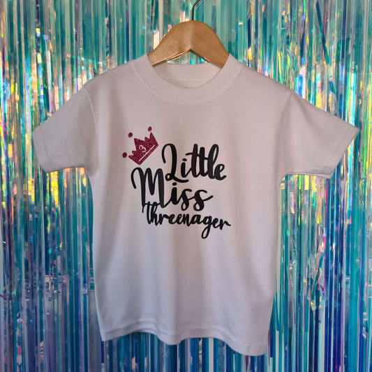 White girl's 3rd Birthday tshirt with black text 'little miss threenage' and glitter pink crown. Made by The Joyful Rebel.