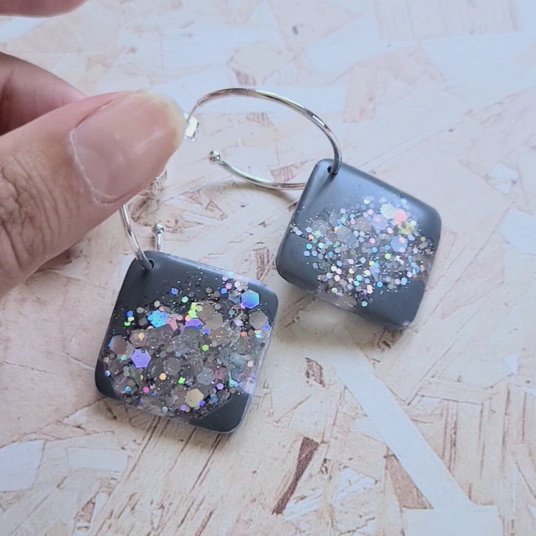 video of grey concrete resin tile earrings