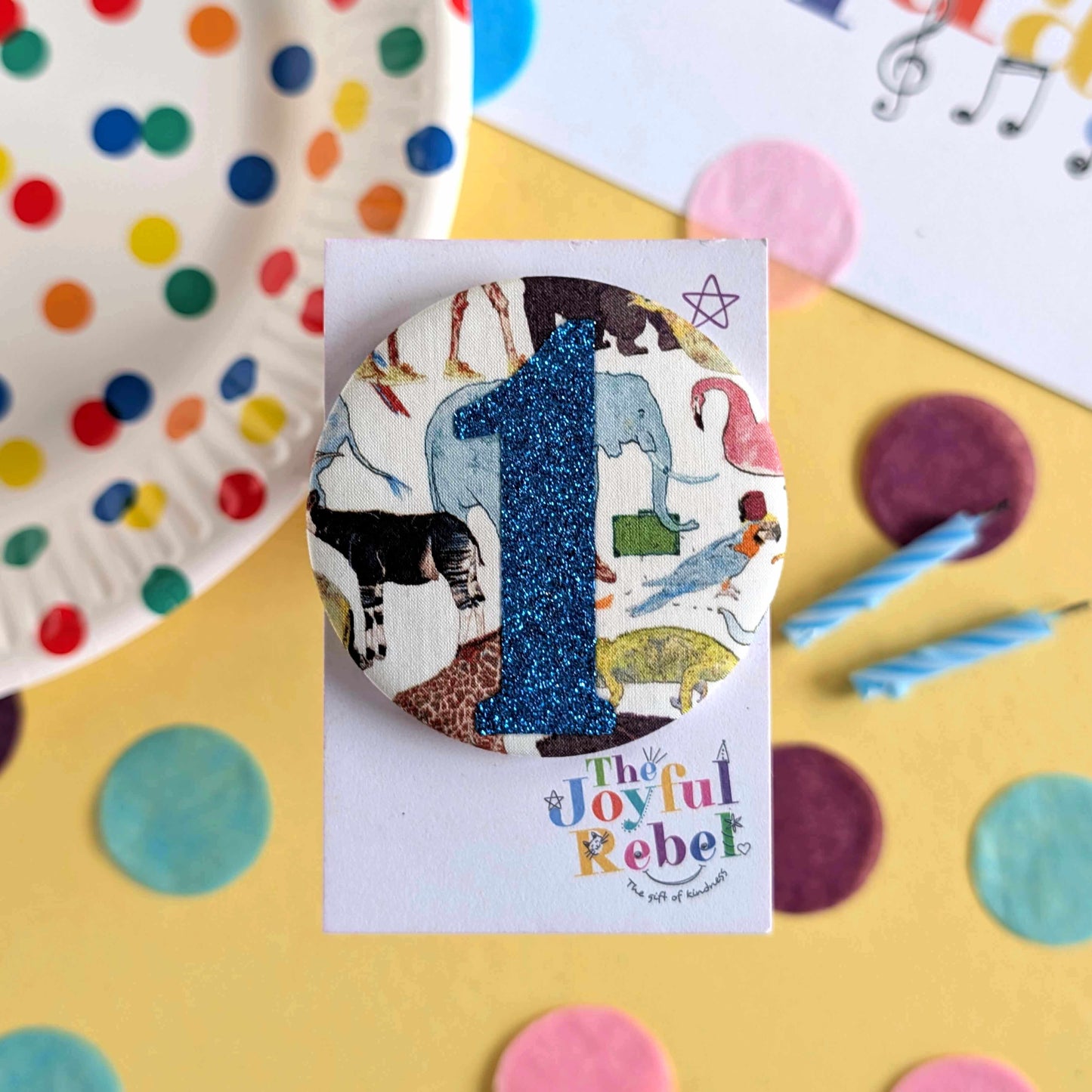Button badge with number 1 and animal design on a colorful background