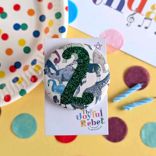 Decorative number '2' with animal illustrations on a colourful background