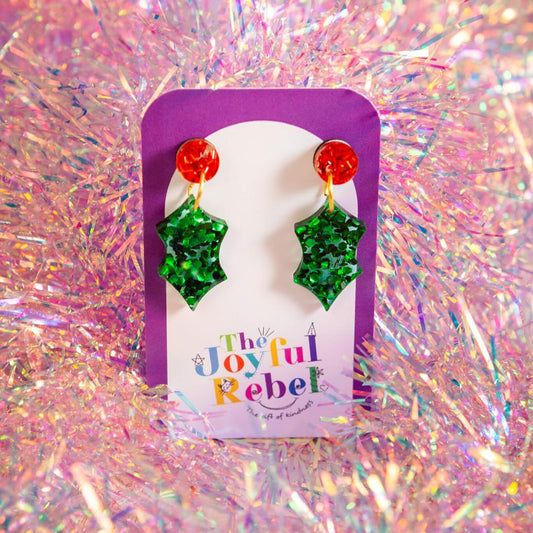 Holly earrings on a 'The Joyful Rebel' branded card with a colourful glittery background. 
