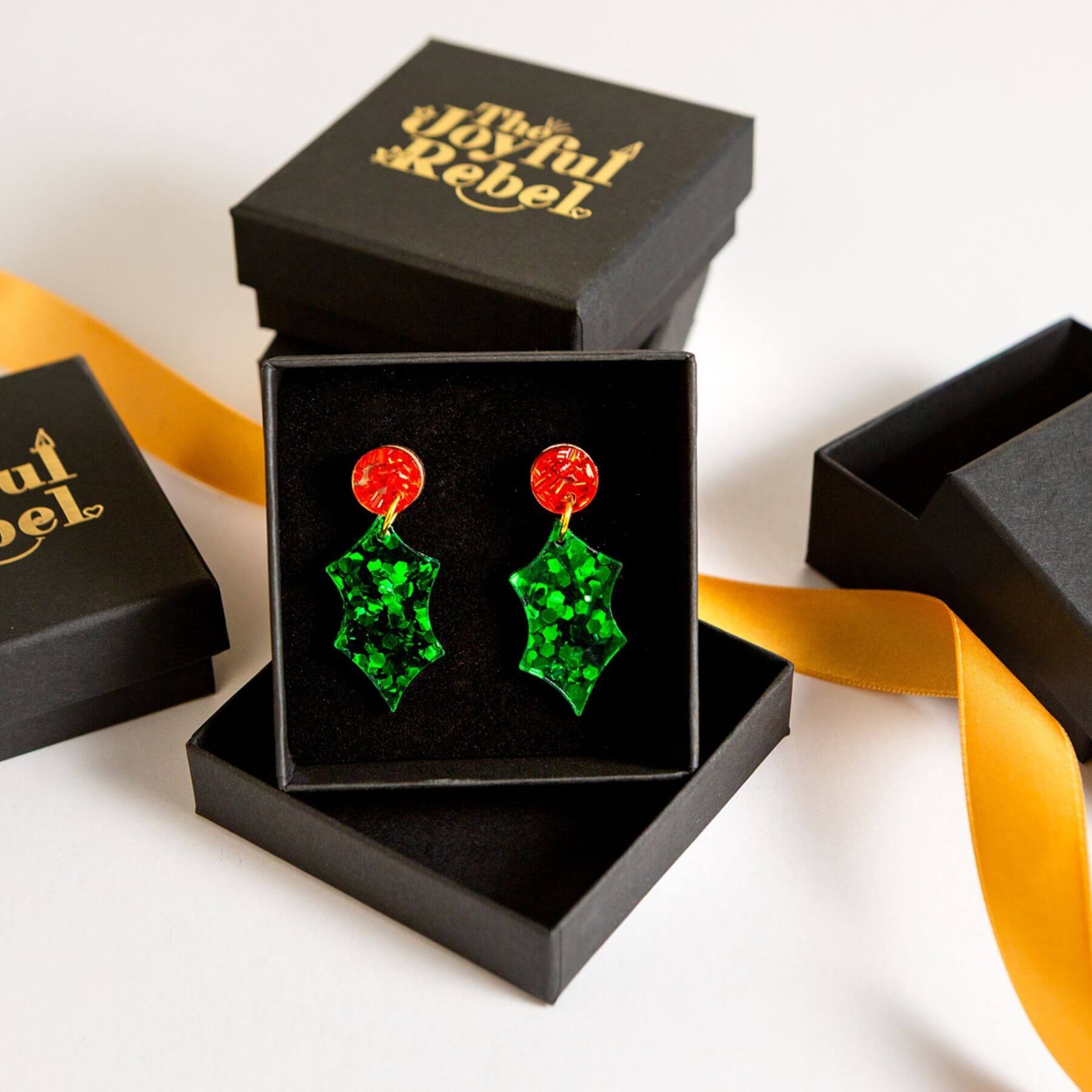 Christmas holly earrings in a black jewellery gift box