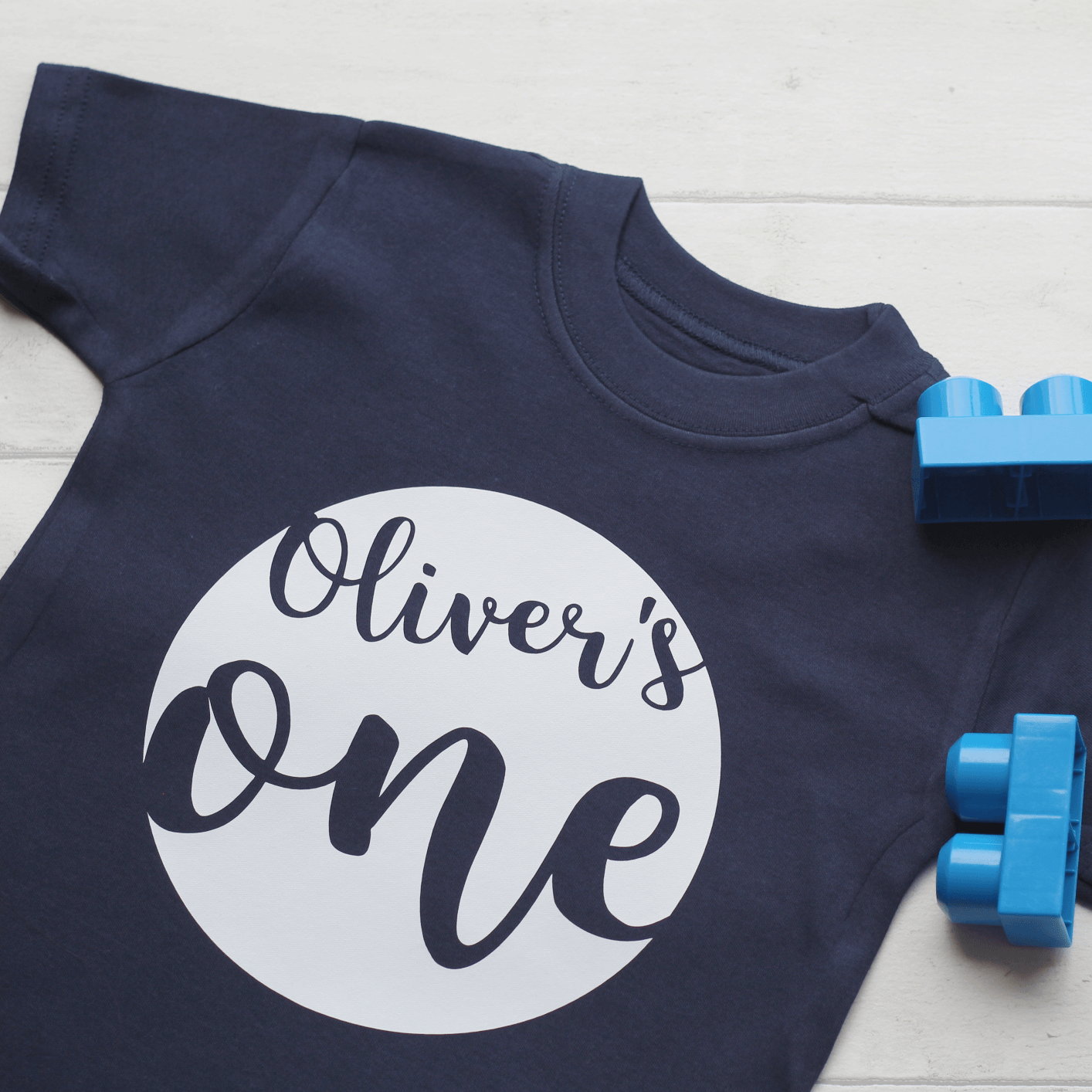 Navy tshirt with white print 'Oliver's one'. Birthday tshirt by the joyful rebel