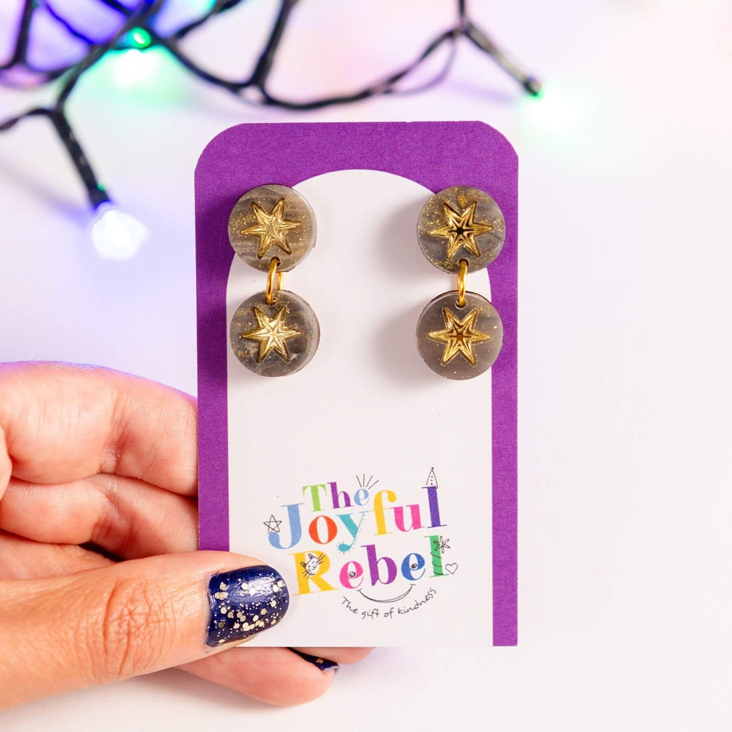 Grey marble constellation earrings presented on a jewellery card