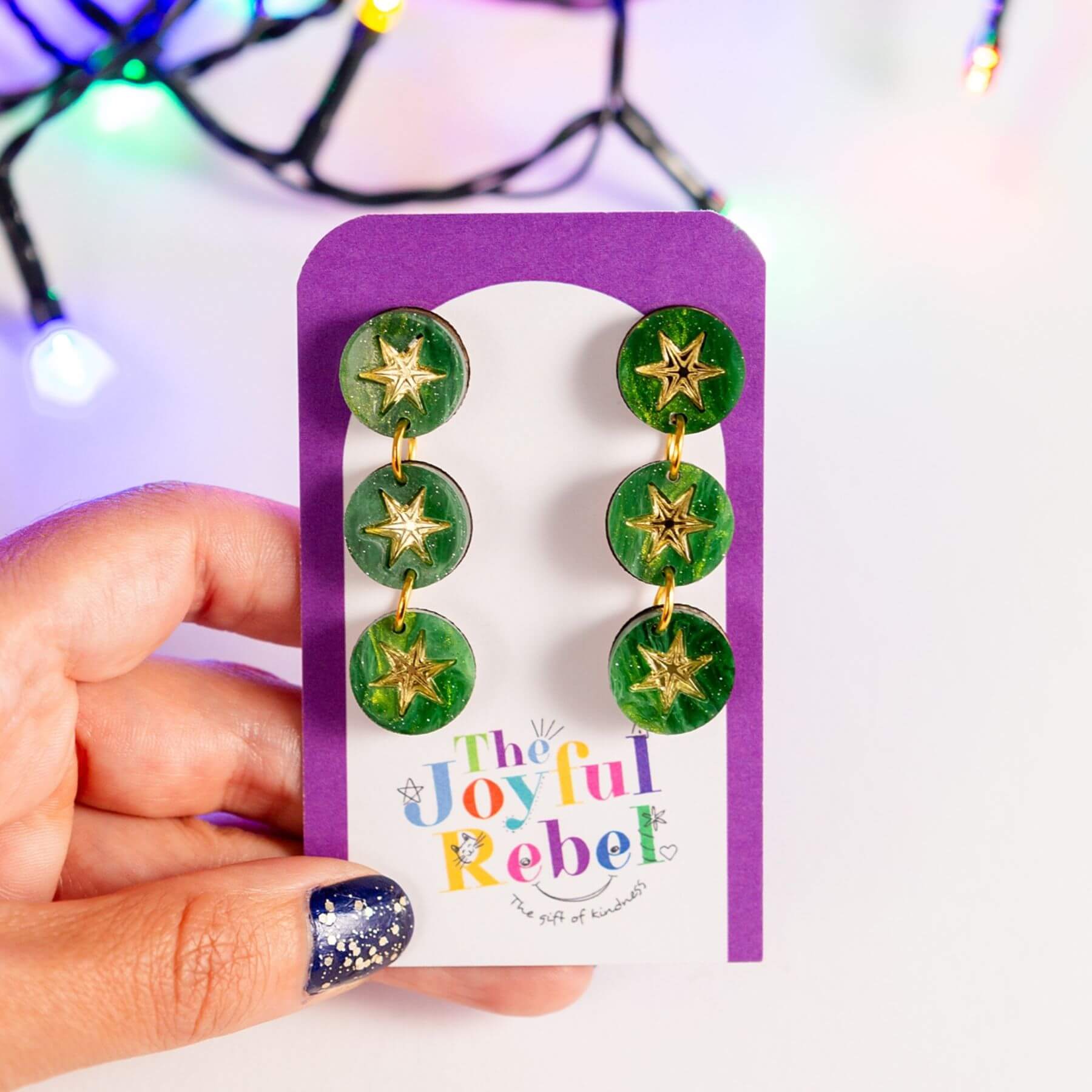Green marble constellation earrings presented on a jewellery card