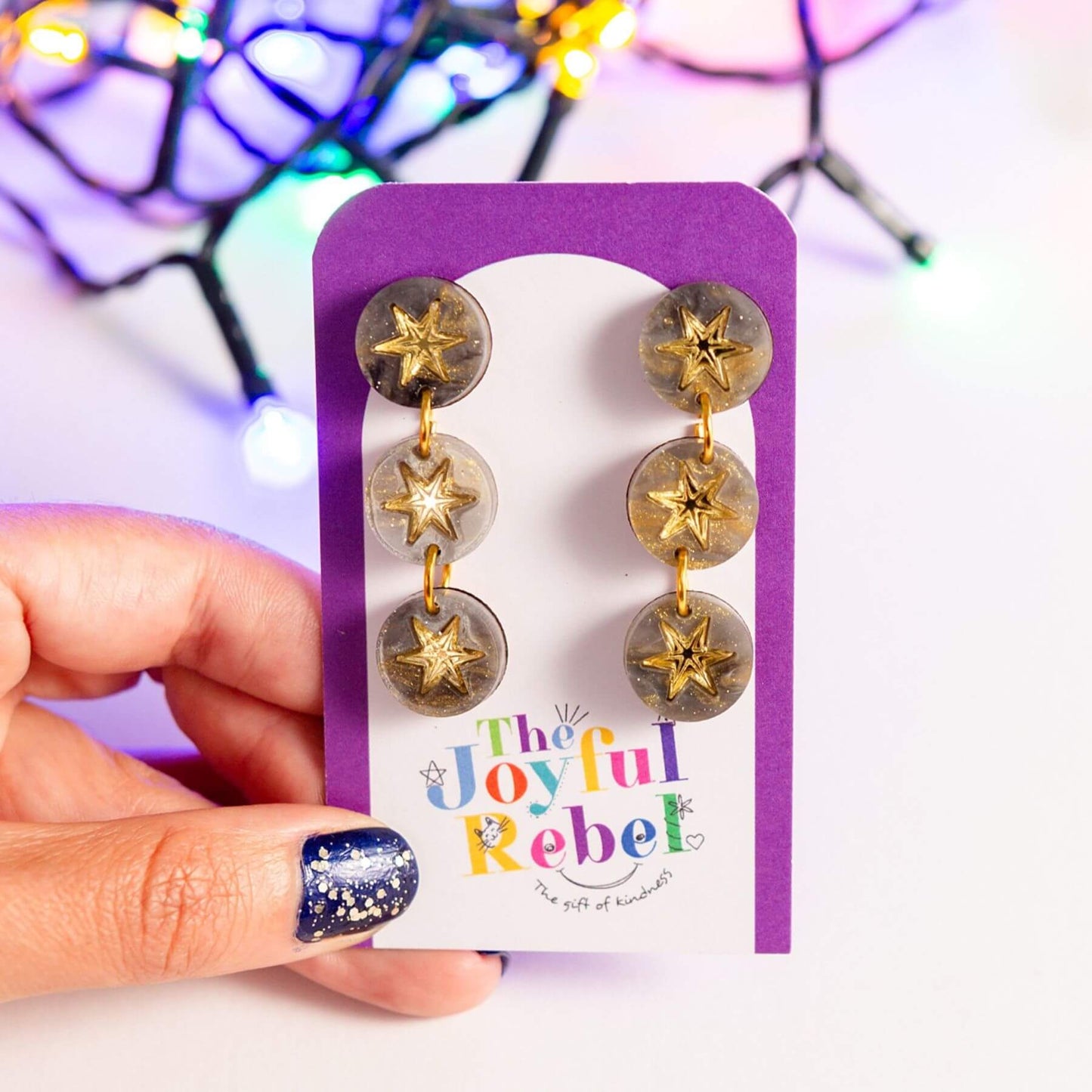 Grey marble constellation earrings presented on a jewellery card