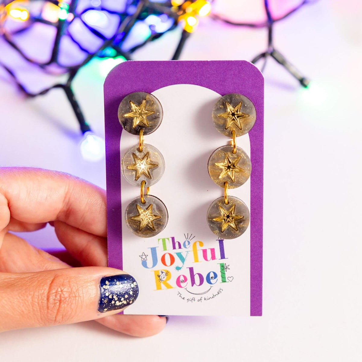 Grey marble constellation earrings presented on a jewellery card