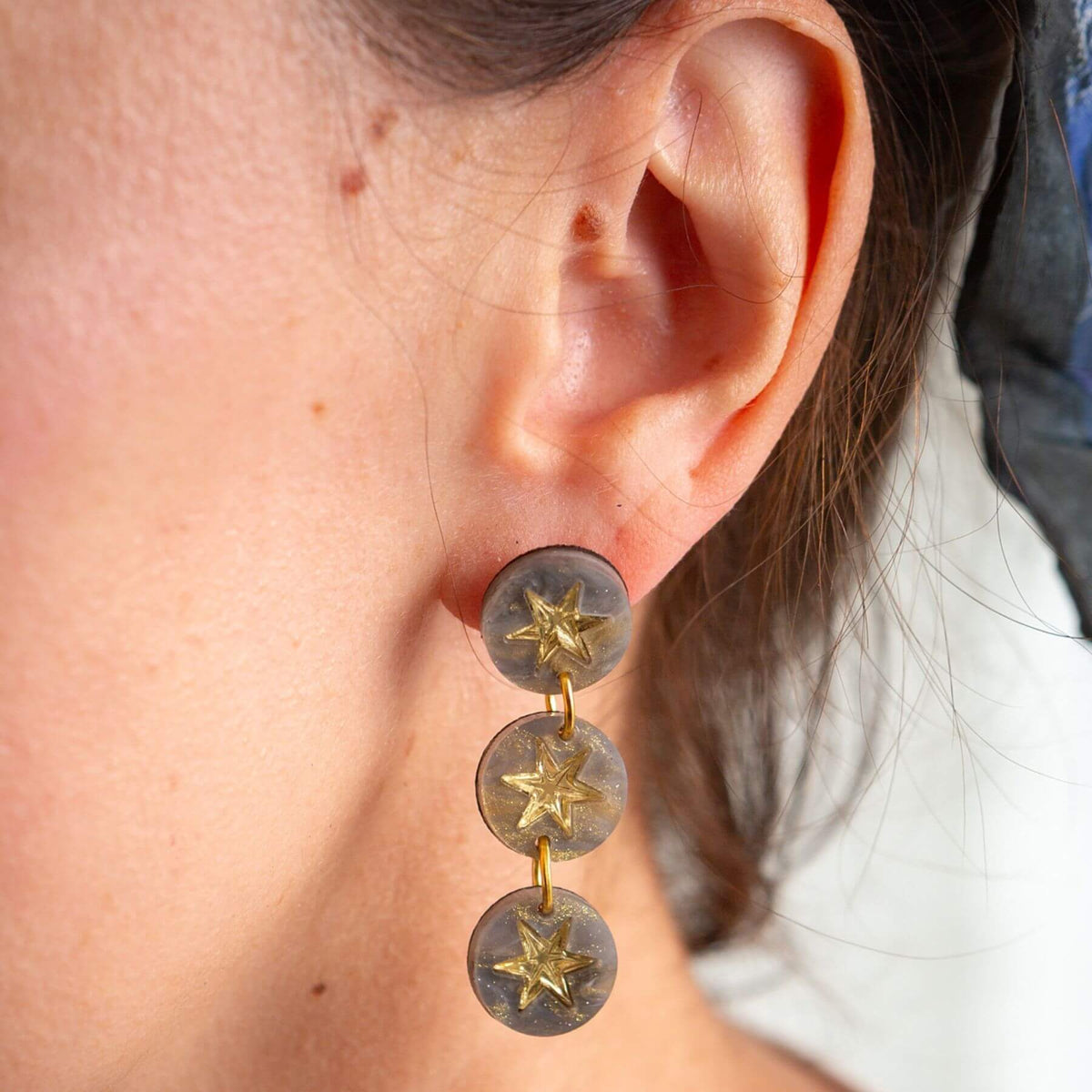 Handmade grey marble triple drop earrings worn as statement jewellery