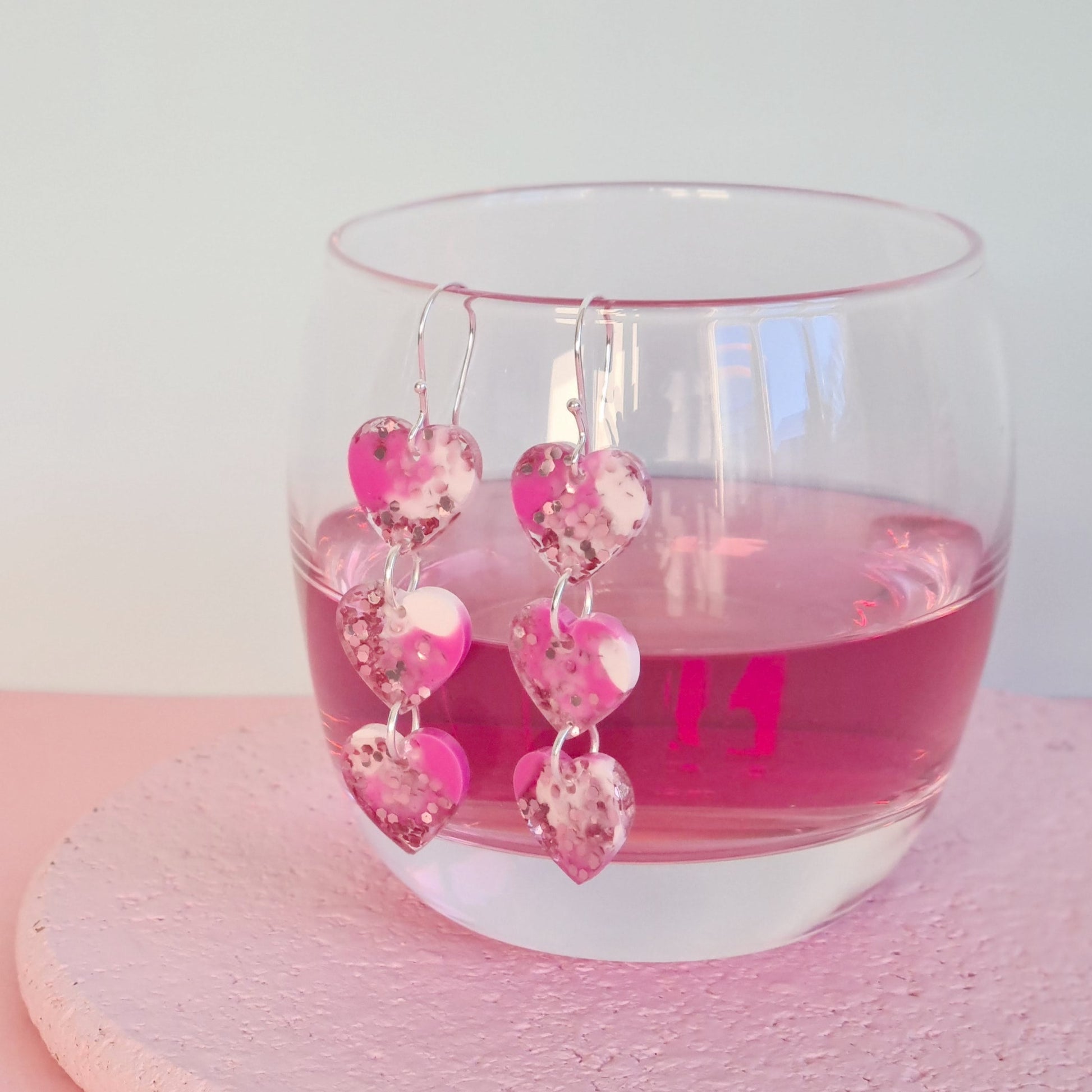 Long dangly earring made from resin pink marble  hearts with shepherd hook