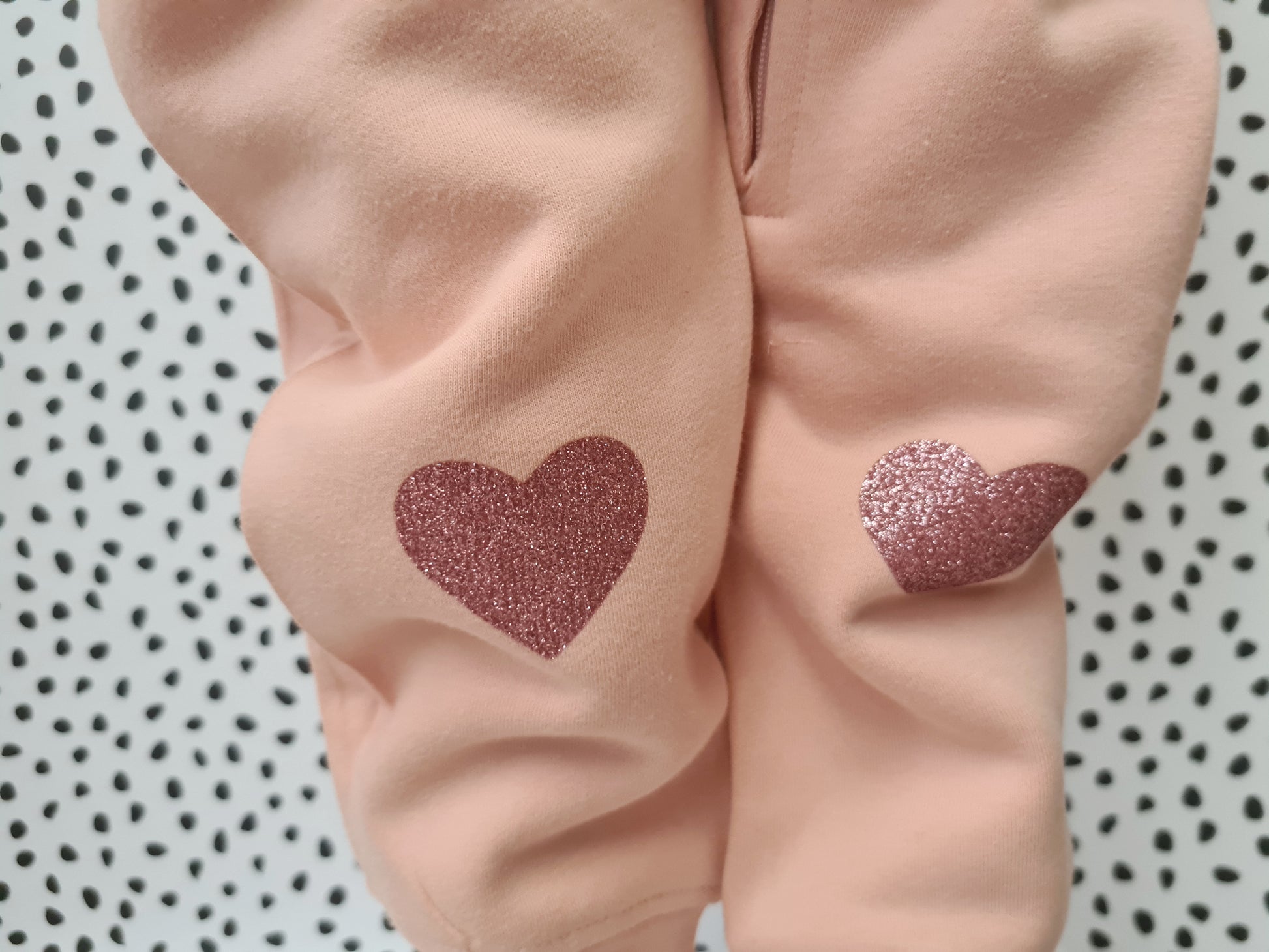 pink fleece suit with hearts on knees